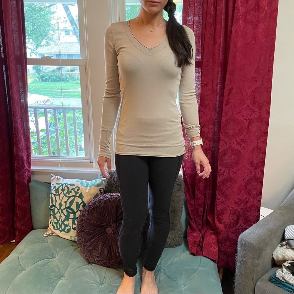 Tan long sleeve, fitted women’s top.